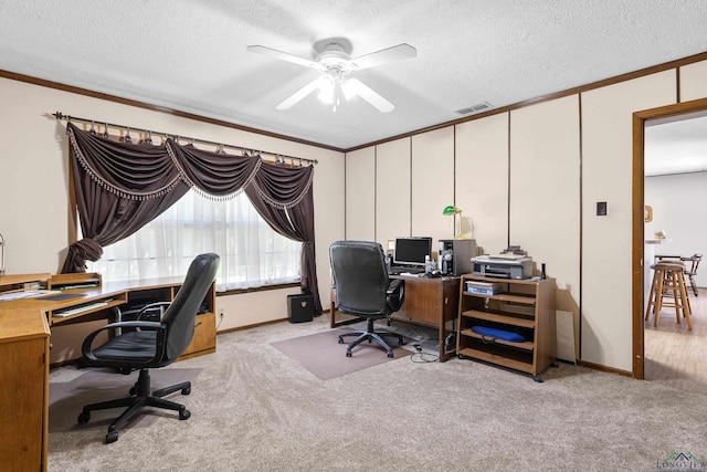 home office with a ceiling fan, carpet flooring, a textured ceiling, ornamental molding, and baseboards