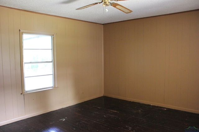 403 N Foster, Linden, TX 75563 - empty room featuring hardwood / wood-style flooring, ceiling fan, wood walls, a textured ceiling, and crown molding