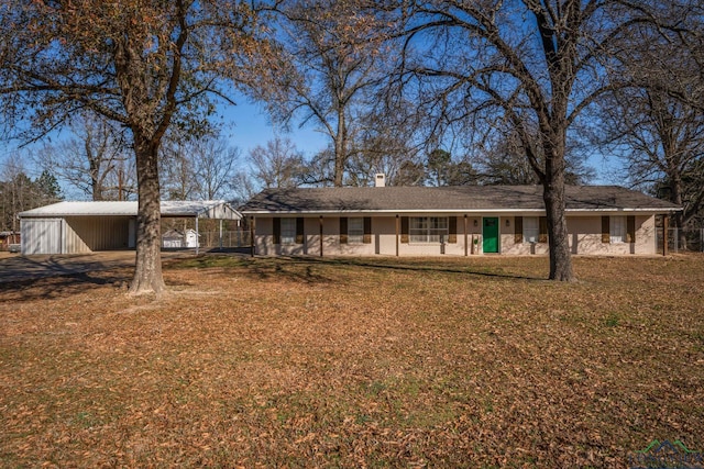 3697 N White Oak Rd, Gladewater, TX 75647 - view of front of house with a carport, a chimney, a front yard, and an outdoor structure