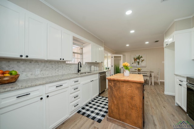 3697 N White Oak Rd, Gladewater, TX 75647 - kitchen with dishwasher, ornamental molding, decorative backsplash, a sink, and butcher block counters