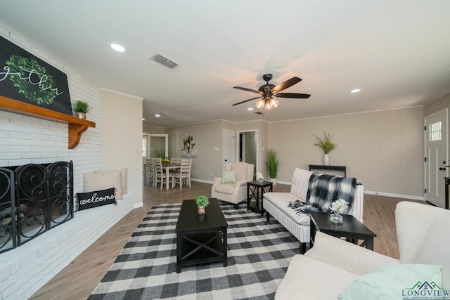 3697 N White Oak Rd, Gladewater, TX 75647 - living area featuring wood finished floors, recessed lighting, a brick fireplace, ceiling fan, and ornamental molding