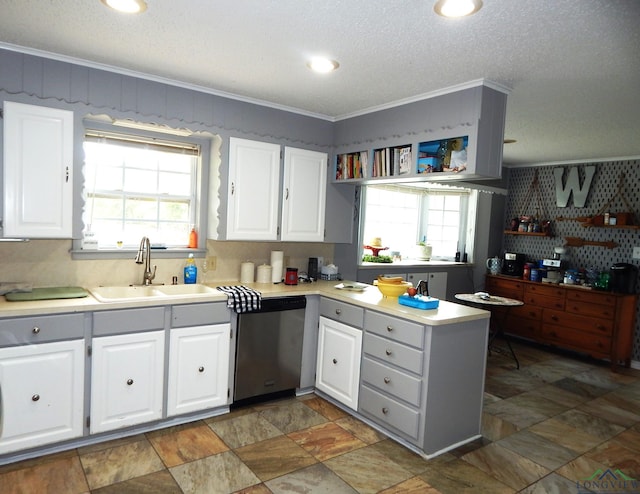 kitchen featuring stainless steel dishwasher, white cabinets, ornamental molding, and sink