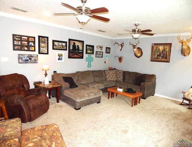 living room featuring carpet, a textured ceiling, ceiling fan, and ornamental molding