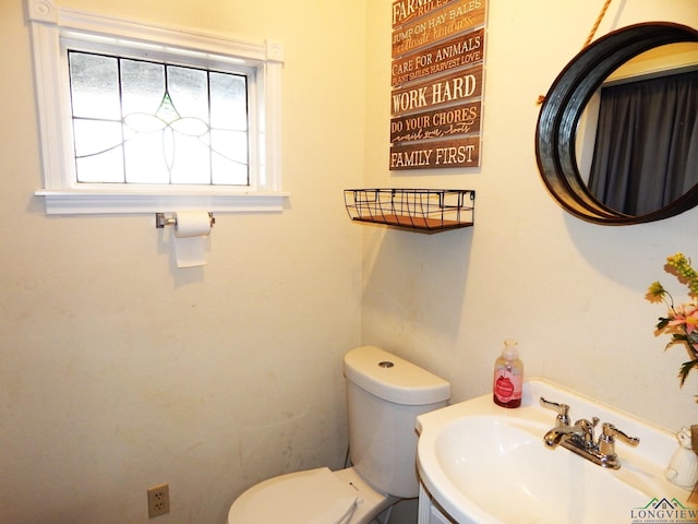 bathroom featuring toilet and sink