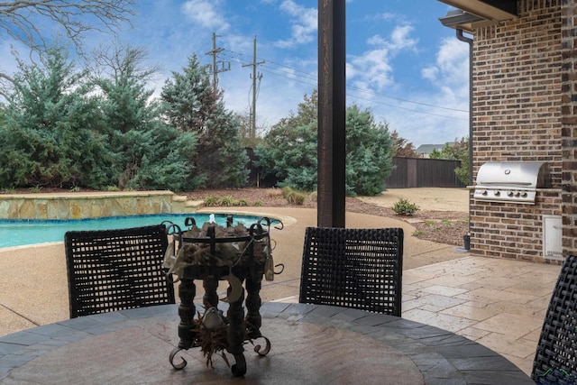 view of patio / terrace with an outdoor pool, fence, grilling area, and area for grilling