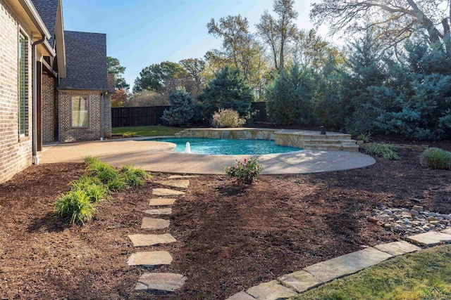 outdoor pool with a patio and a fenced backyard