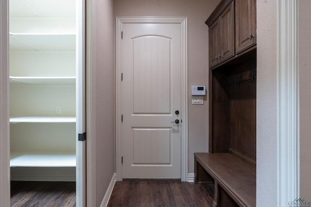 mudroom featuring dark wood-style floors and baseboards