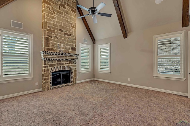 unfurnished living room featuring a ceiling fan, beamed ceiling, carpet flooring, a fireplace, and high vaulted ceiling