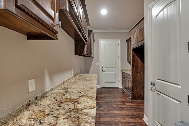 interior space with dark wood-type flooring and visible vents