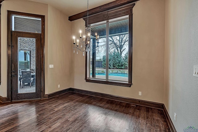 interior space with an inviting chandelier, baseboards, and dark wood-style flooring