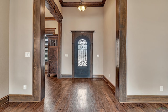 entrance foyer featuring baseboards, dark wood-type flooring, and ornamental molding