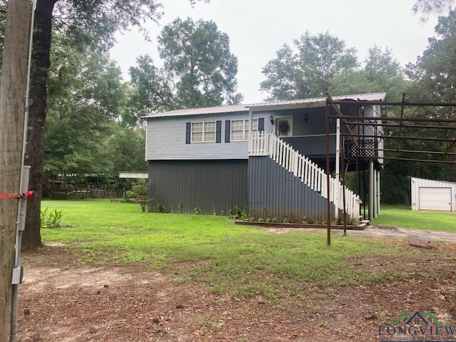 view of front facade with a wooden deck and a front lawn