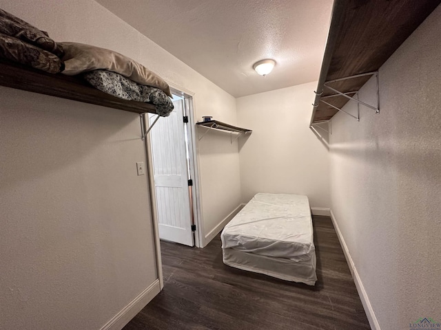 spacious closet with dark hardwood / wood-style floors