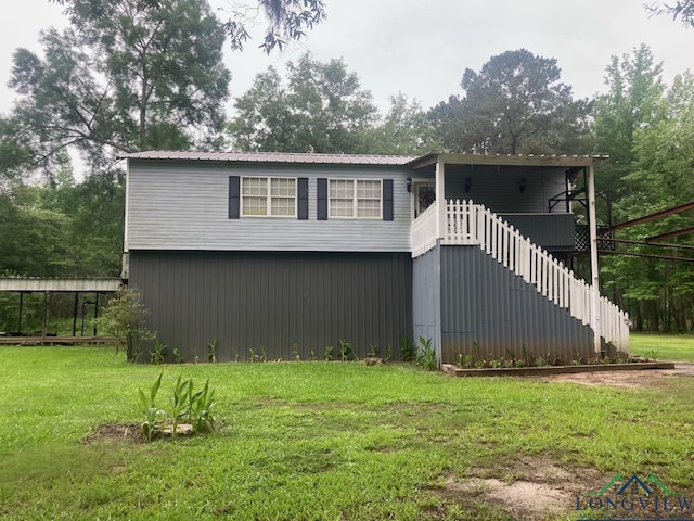 rear view of property featuring a yard