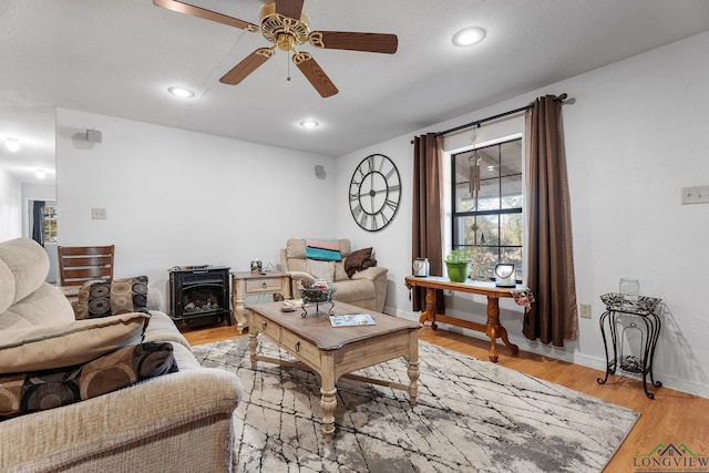 living room with light hardwood / wood-style floors and ceiling fan