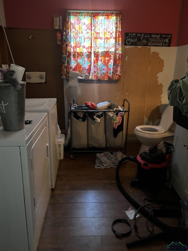 clothes washing area with wood-type flooring and washer and clothes dryer