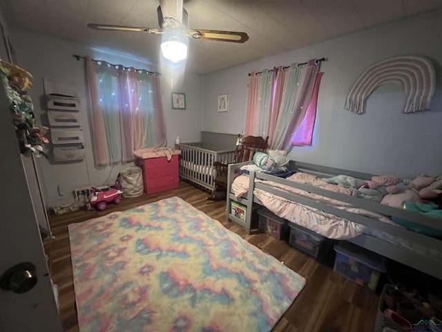 bedroom with ceiling fan and dark hardwood / wood-style floors