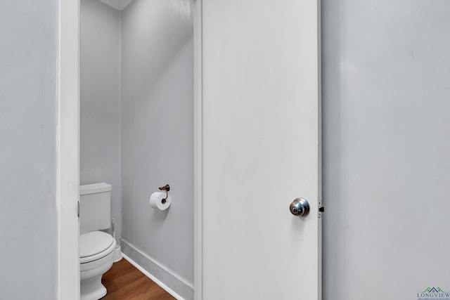 1228 Hillcrest Dr, Longview, TX 75601 - bathroom featuring toilet and wood finished floors