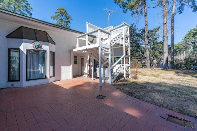 1228 Hillcrest Dr, Longview, TX 75601 - back of property featuring stairway, a patio, and stucco siding