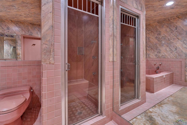 1228 Hillcrest Dr, Longview, TX 75601 - bathroom with tile walls, a garden tub, a shower stall, recessed lighting, and tile patterned floors