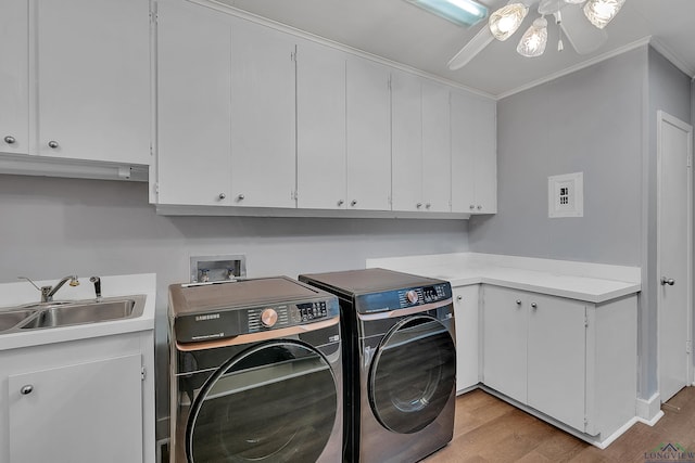 1228 Hillcrest Dr, Longview, TX 75601 - laundry room with washer and dryer, cabinet space, ornamental molding, light wood-style flooring, and ceiling fan