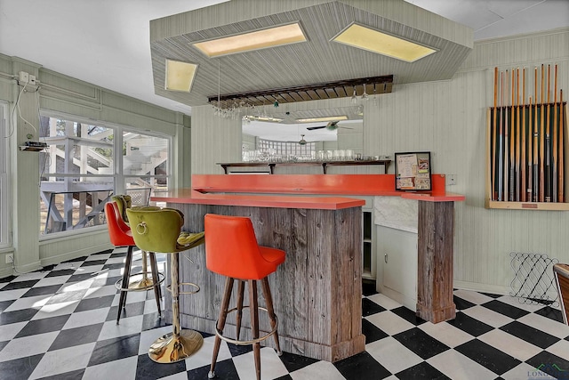 1228 Hillcrest Dr, Longview, TX 75601 - indoor dry bar with tile patterned floors and a ceiling fan