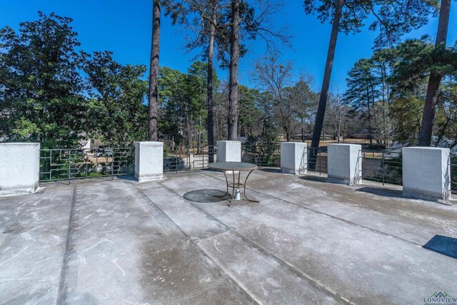 1228 Hillcrest Dr, Longview, TX 75601 - view of patio / terrace featuring view of wooded area