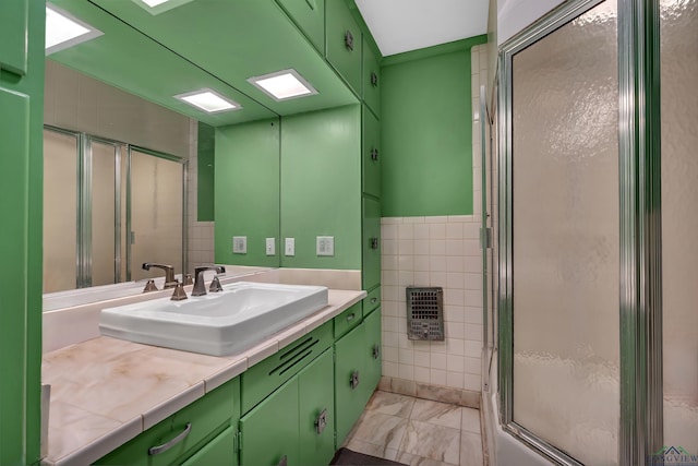 1228 Hillcrest Dr, Longview, TX 75601 - full bath featuring a shower stall, tile walls, vanity, and marble finish floors