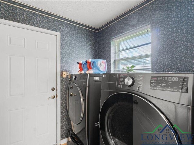 1009 Sequoyah Ln, Longview, TX 75605 - washroom with washing machine and clothes dryer and crown molding
