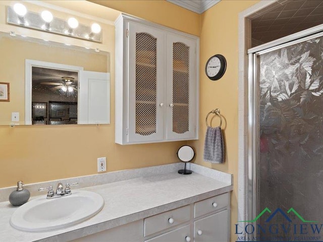 1009 Sequoyah Ln, Longview, TX 75605 - bathroom with a shower stall, vanity, a ceiling fan, and ornamental molding