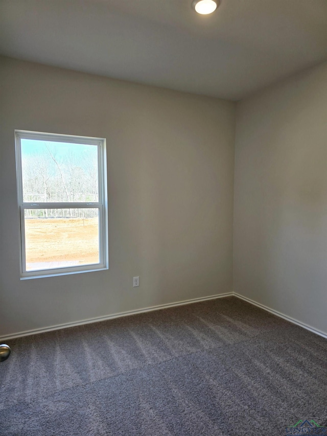 empty room featuring dark colored carpet