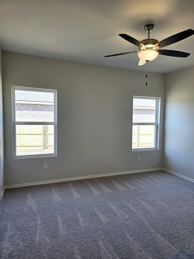 spare room with ceiling fan, carpet floors, and a healthy amount of sunlight