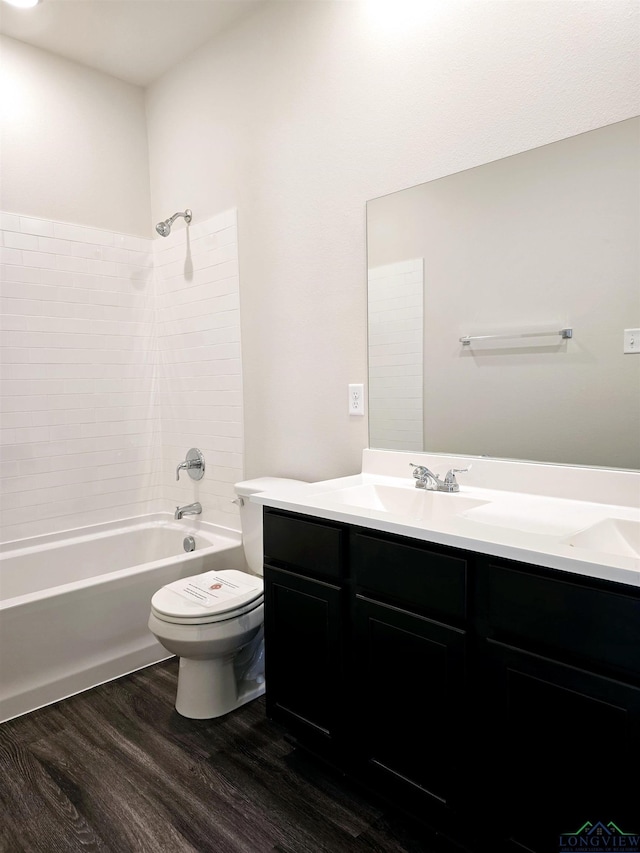 full bathroom with wood-type flooring, toilet, shower / bath combination, and vanity