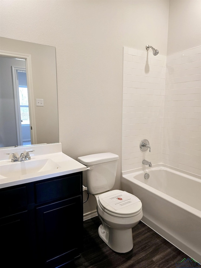 full bathroom featuring vanity, hardwood / wood-style floors, shower / bathtub combination, and toilet