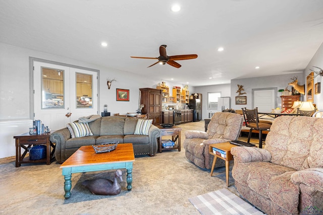 living room with ceiling fan and light carpet