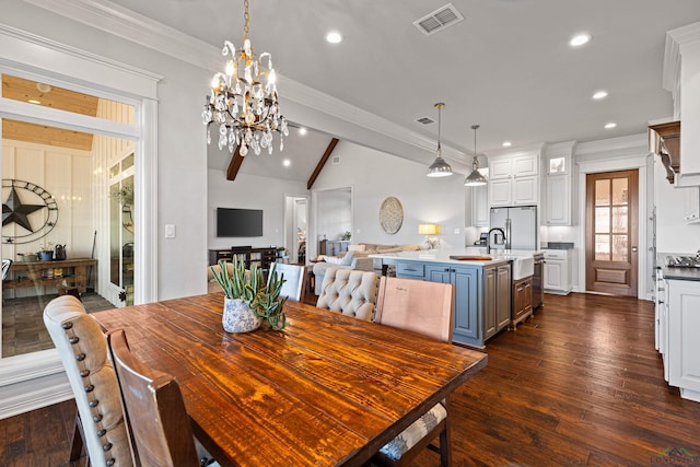 dining space with lofted ceiling with beams, dark hardwood / wood-style floors, sink, and a chandelier