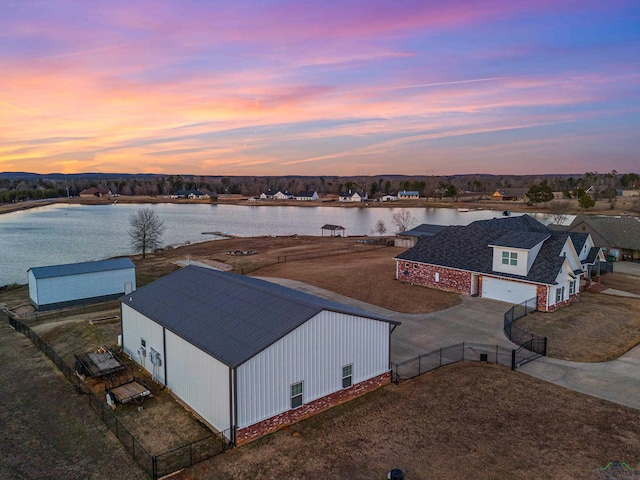 aerial view at dusk with a water view