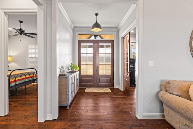 foyer featuring ornamental molding, dark hardwood / wood-style flooring, and french doors