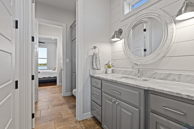 bathroom featuring plenty of natural light, toilet, and vanity