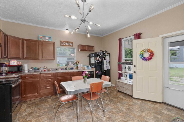 1105 N Bolivar, Marshall, TX 75670 - kitchen featuring black appliances, a chandelier, a textured ceiling, healthy amount of natural light, and brown cabinets