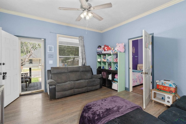 1105 N Bolivar, Marshall, TX 75670 - living area featuring wood finished floors, ornamental molding, and a ceiling fan