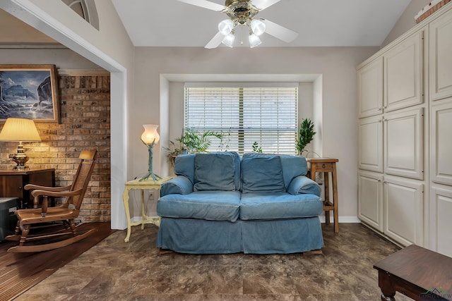 living area featuring ceiling fan and lofted ceiling