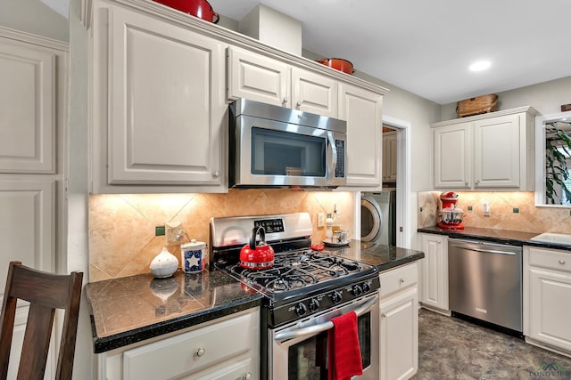 kitchen with white cabinets, sink, decorative backsplash, washer / dryer, and stainless steel appliances