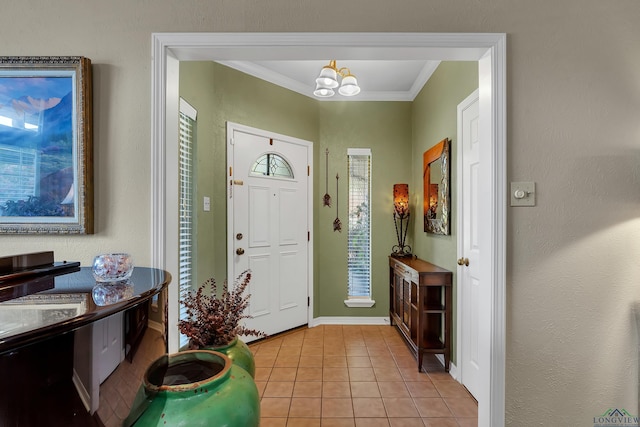 tiled foyer with crown molding and a notable chandelier