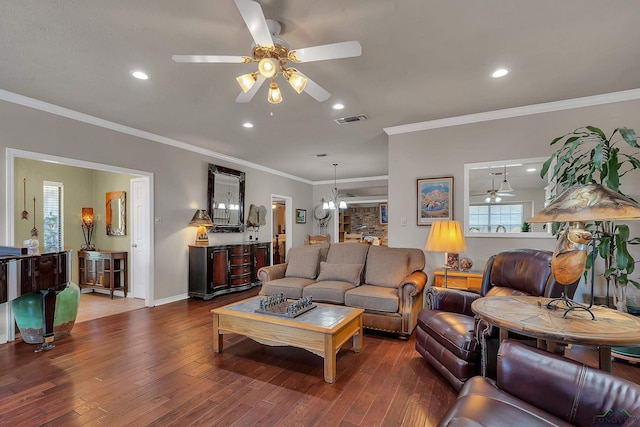 living room featuring crown molding, wood-type flooring, and ceiling fan with notable chandelier