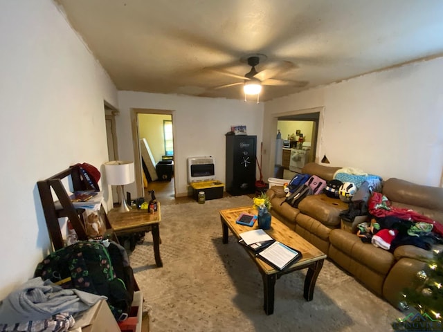 living room with heating unit and ceiling fan