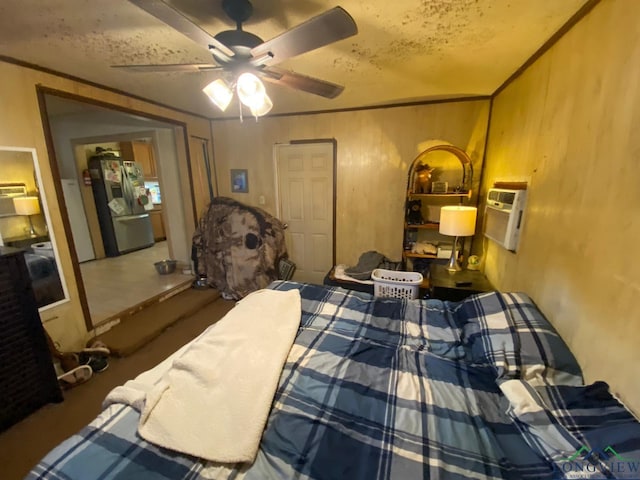 bedroom featuring stainless steel refrigerator with ice dispenser, a textured ceiling, ceiling fan, and ornamental molding