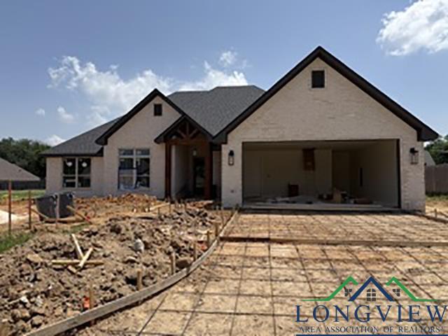 208 Lafoy Ln, Hallsville, TX 75650 - view of front facade featuring an attached garage and driveway