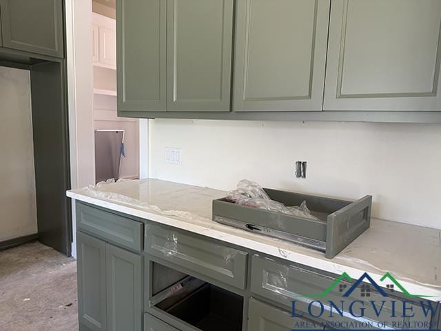 208 Lafoy Ln, Hallsville, TX 75650 - kitchen featuring light stone counters and green cabinets