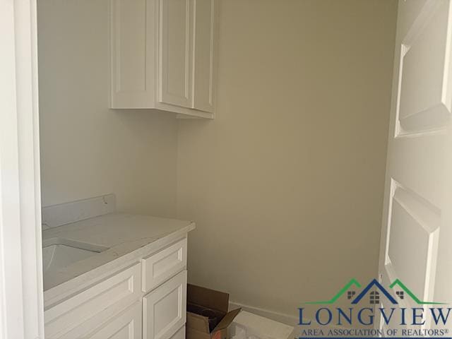 208 Lafoy Ln, Hallsville, TX 75650 - laundry room featuring a sink and baseboards